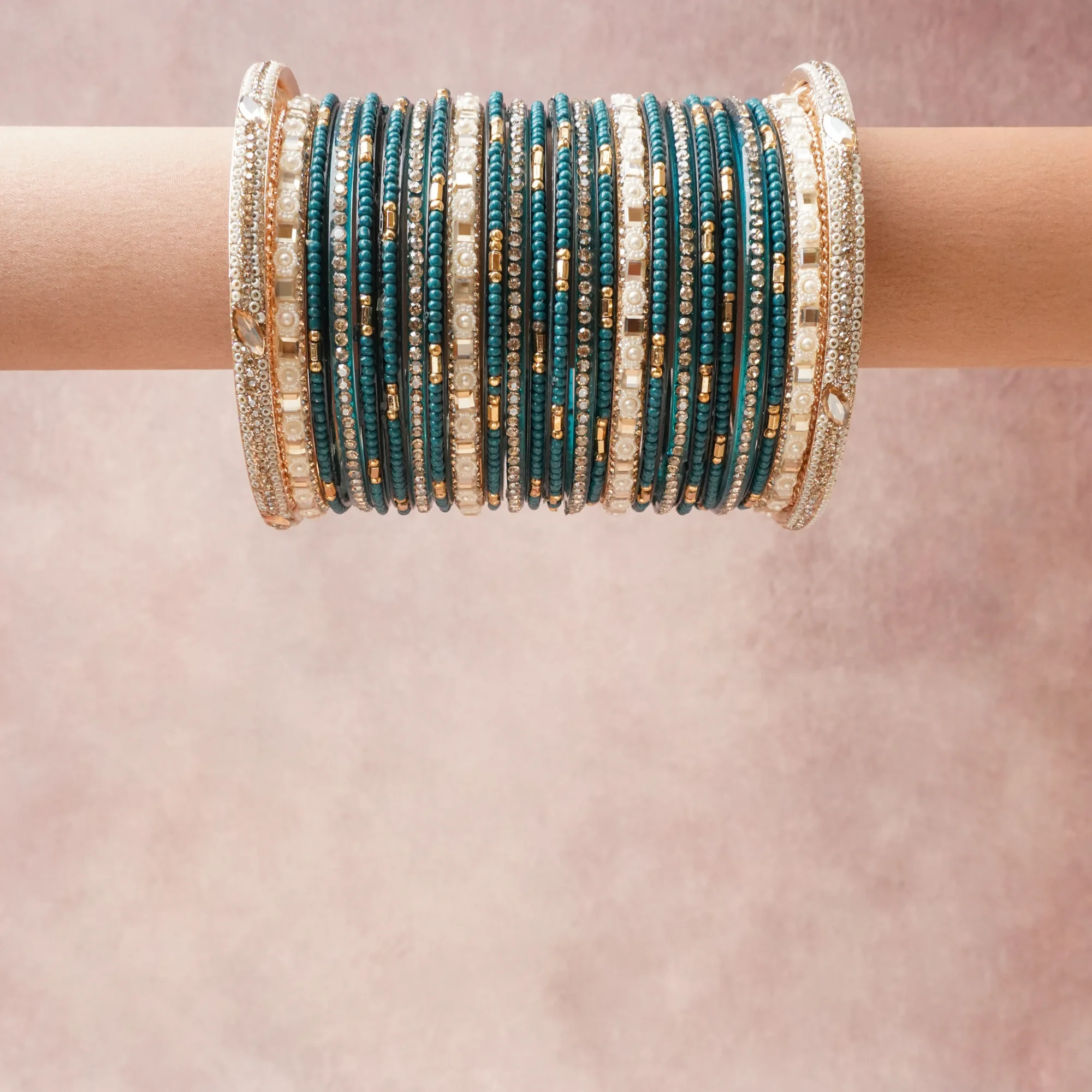 A grounding Teal forms the heart of the set, while touches of Gold, Ivory, Clear add charm.

A thoughtful composition of Glass Beads, Gold-Toned Metal, Simulated Pearls, Rhinestones, designed to feel complete without being heavy.
Each element layers seamlessly, creating a look that is refined, wearable and quietly striking.
